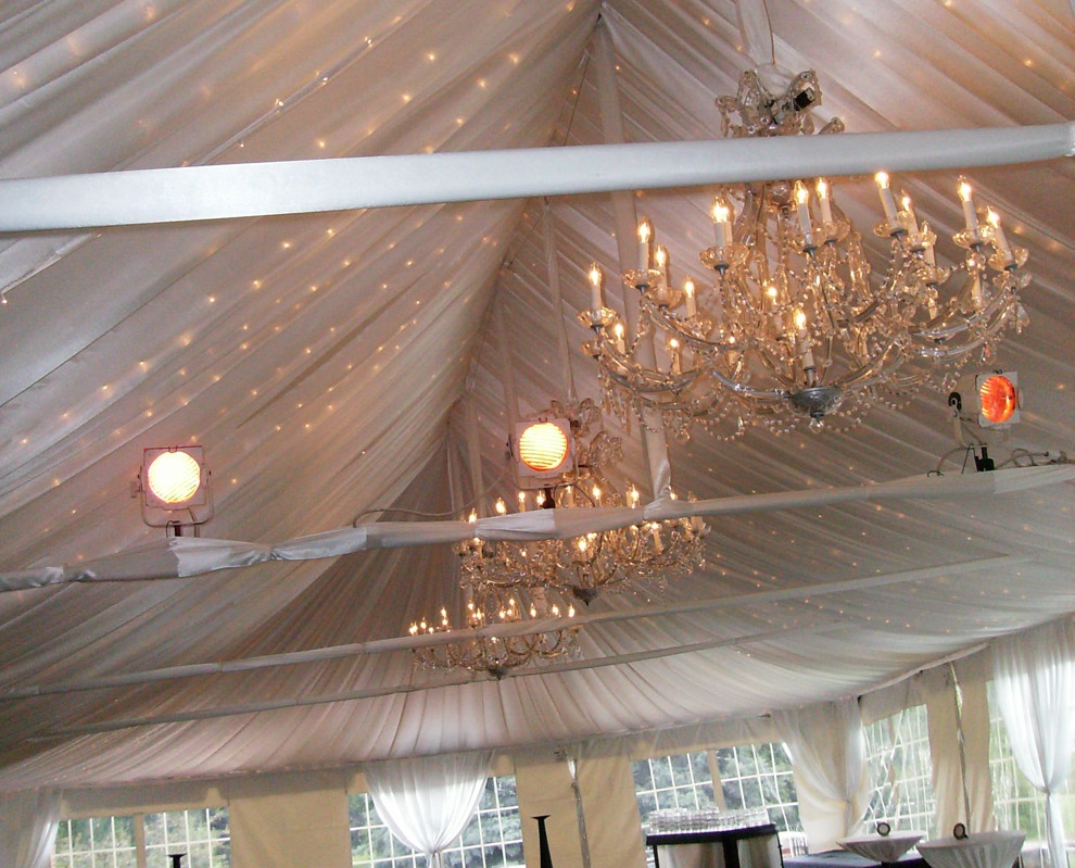 tent wedding with chandeliers and string lights