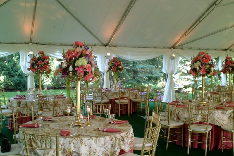 wedding tent with elegant table linens and floral centerpieces