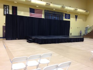 Black Pipe and Drape Wall behind Skirted Stage for winter graduation
