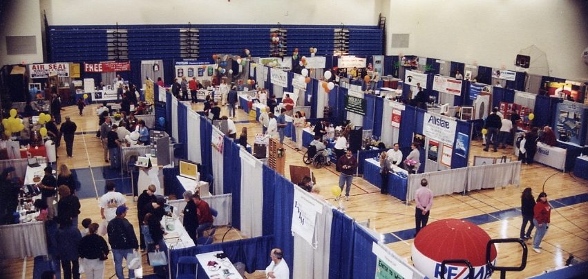 trade show with blue and white pipe and drapes
