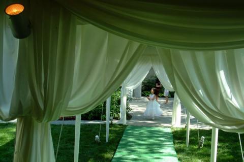 wedding tent entrance idea with green and white drapes