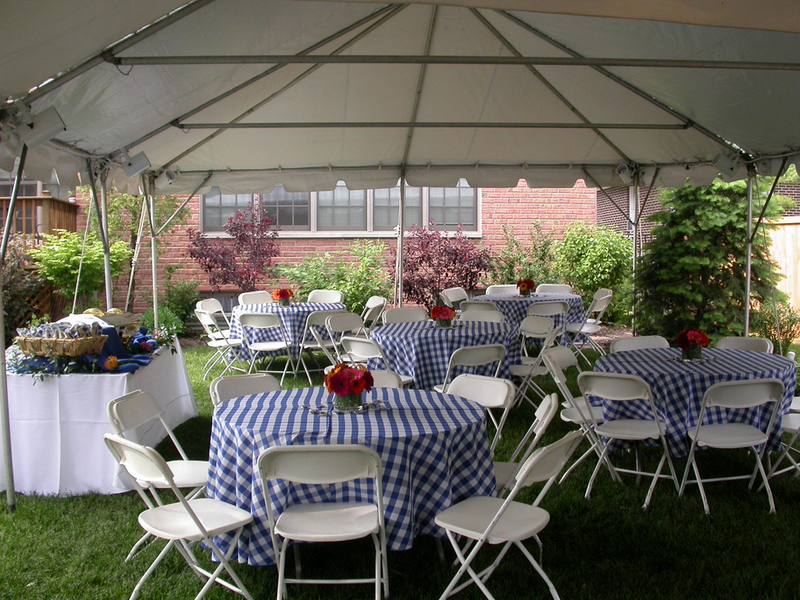 backyard party with round tables and checkered table cloths