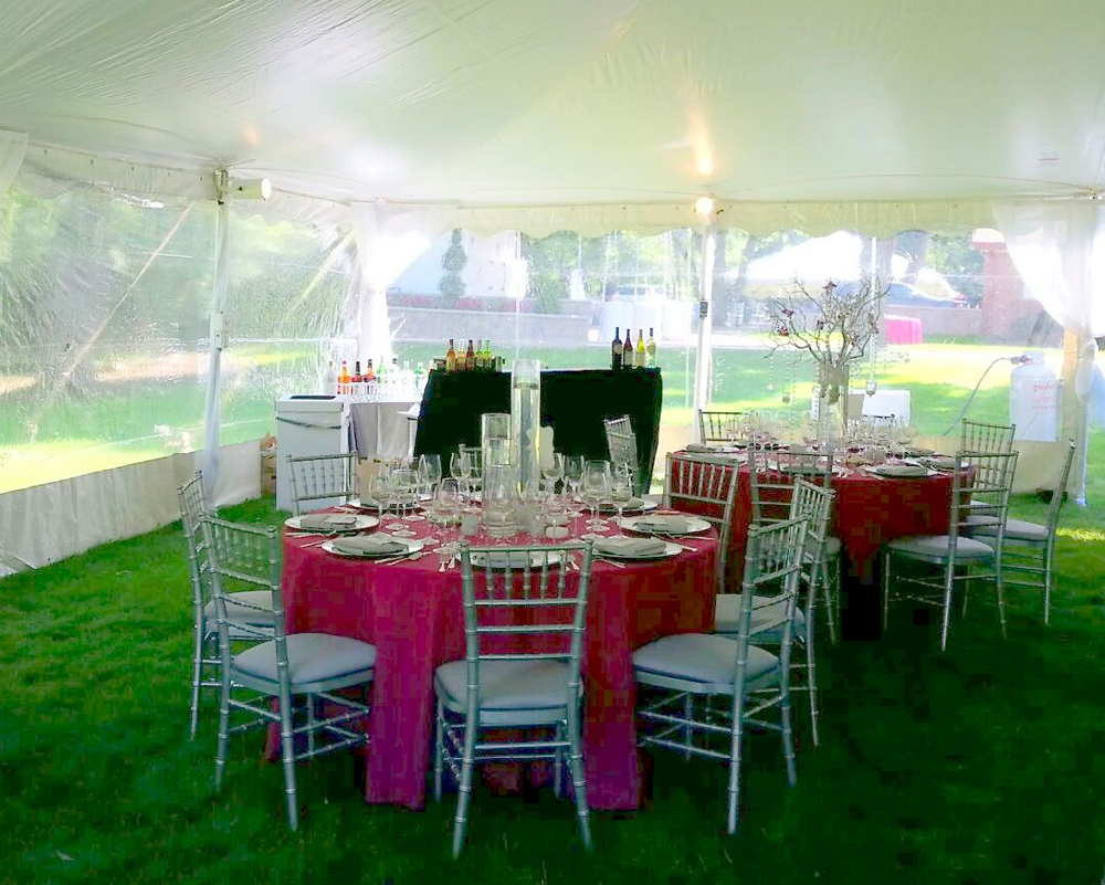 chiavari chair rentals at tented event with table linens and tables