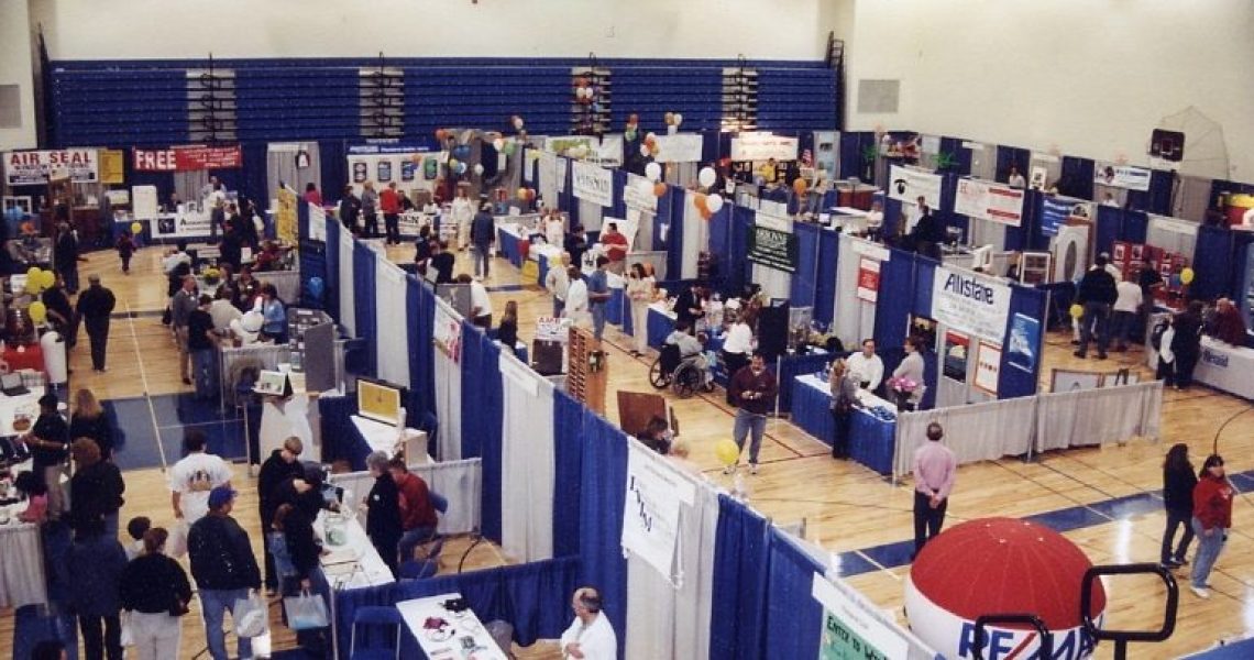 trade show with blue and white pipe and drapes