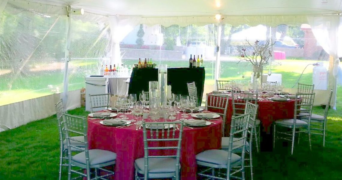 chiavari chair rentals at tented event with table linens and tables