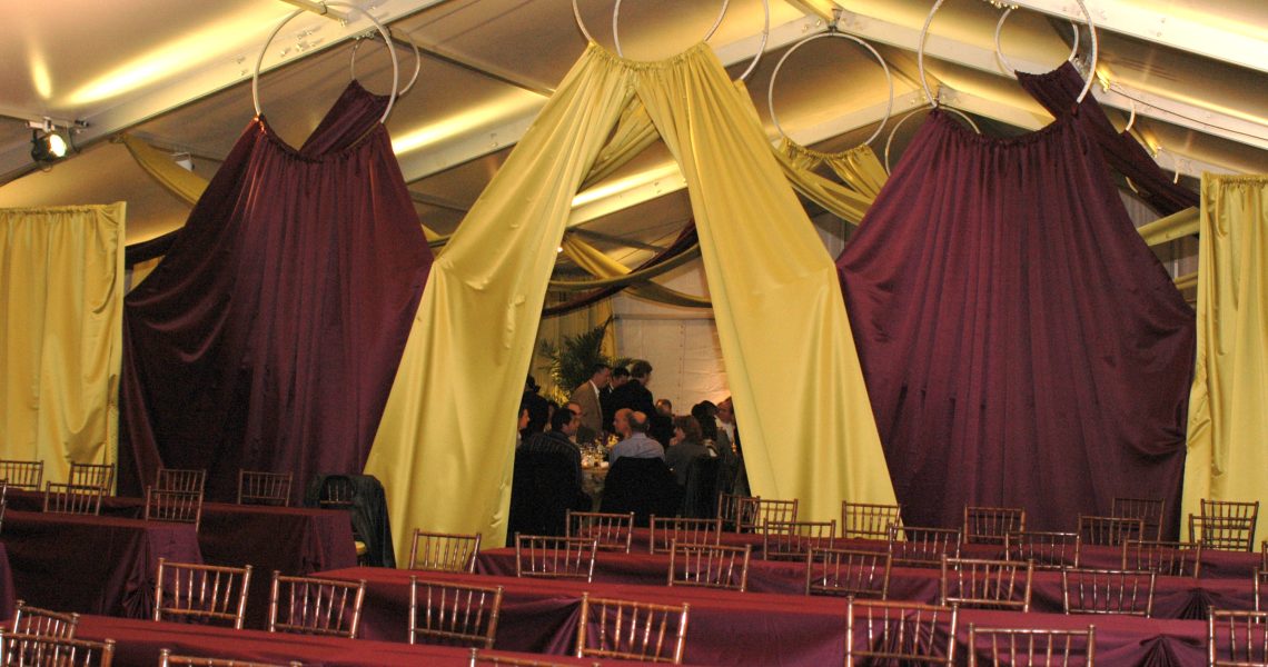 tented event space with tables and chairs